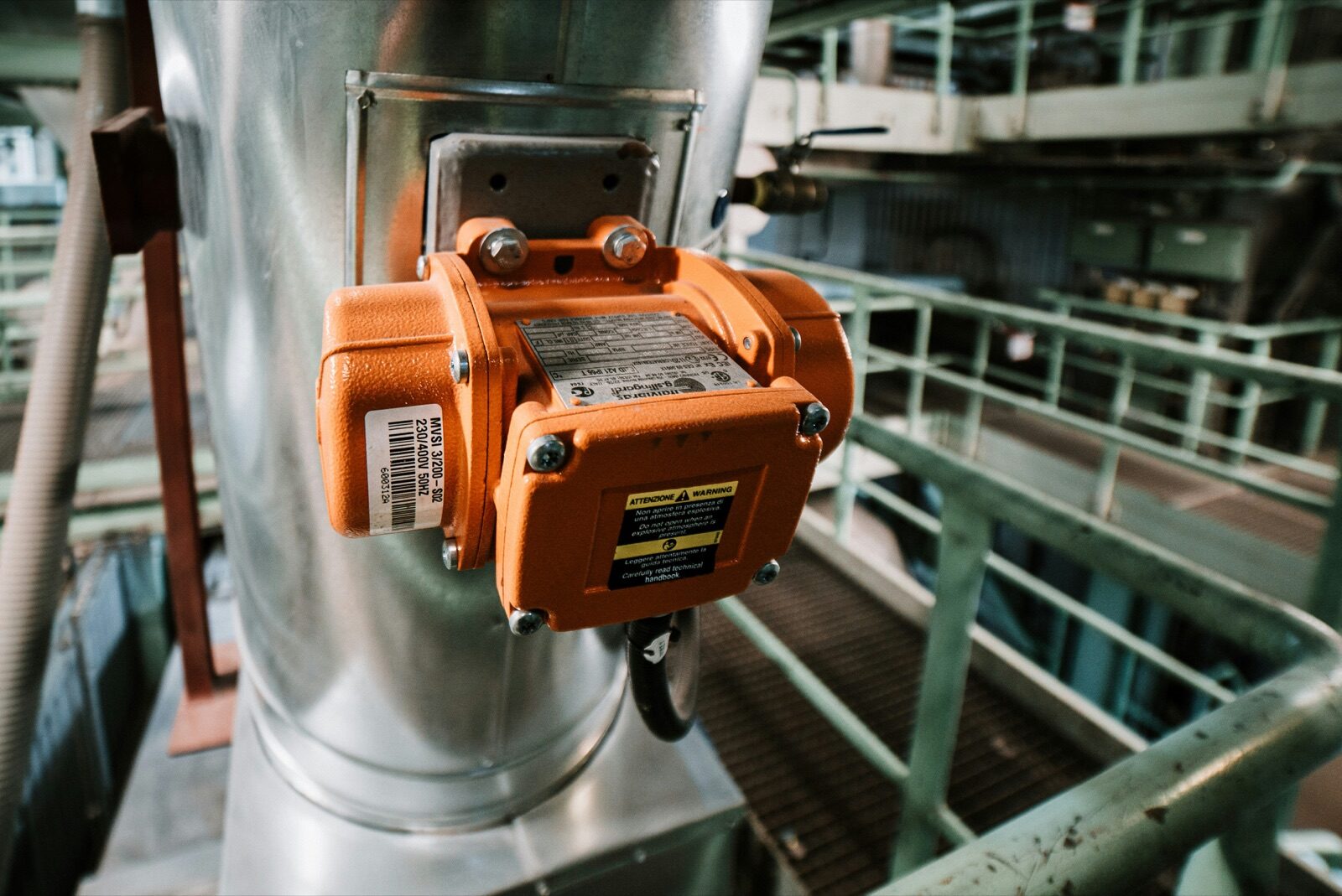 Orange industrial sensor housing mounted on metal ductwork for Epo-Weld™ HTC high temperature coating protection