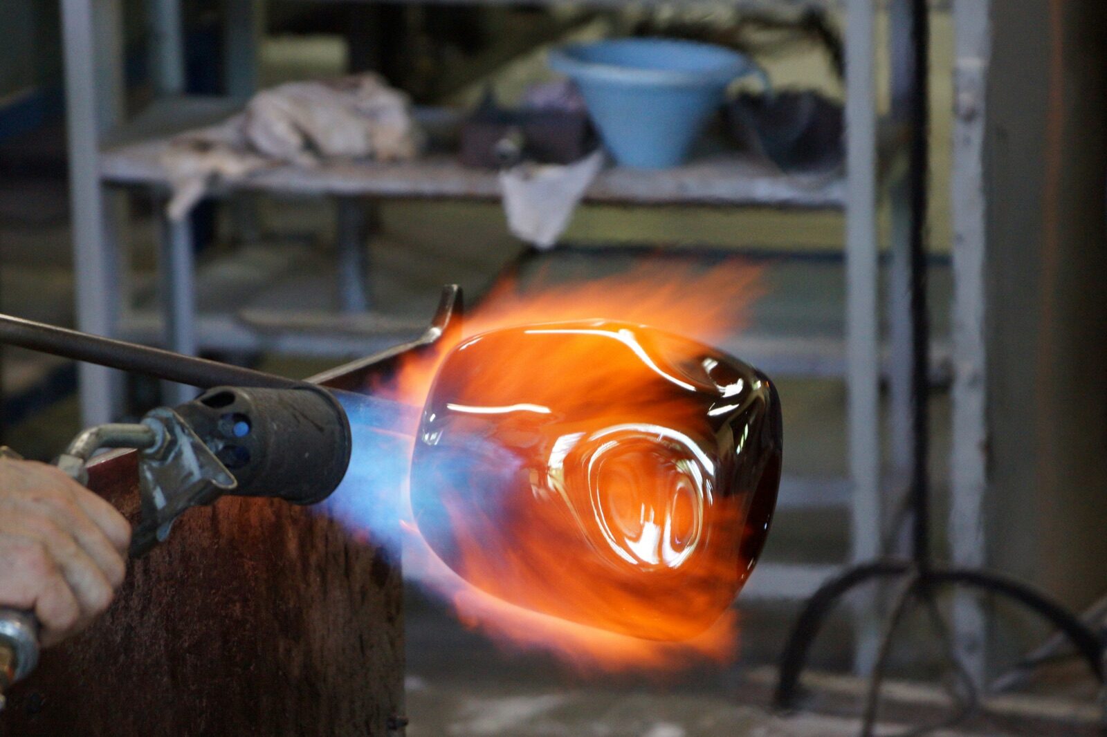 Craftsman shaping molten glass with torch for Epo-Weld™ inorganic binder quartz tube and lamp sealing